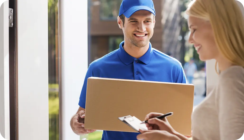 Man with box and woman staying near house